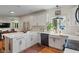 Bright kitchen featuring white cabinets, hardwood floors, subway tile backsplash, and an island at 4601 Fairhope Dr, Indianapolis, IN 46237