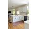 Bright kitchen with white cabinets, hardwood floors, and stainless steel appliances, perfect for cooking and entertaining at 4601 Fairhope Dr, Indianapolis, IN 46237