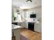 Bright kitchen with white cabinets, stainless steel appliances, and a farmhouse sink, a chef's dream at 4601 Fairhope Dr, Indianapolis, IN 46237