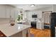 Kitchen featuring white cabinets, subway tile backsplash, island, and stainless steel appliances at 4601 Fairhope Dr, Indianapolis, IN 46237