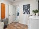 Well lit Laundry Room with modern appliances and an Elvis Presley poster at 4601 Fairhope Dr, Indianapolis, IN 46237
