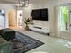 Open living room featuring a large window, modern media center, and plush seating over soft carpet for ultimate comfort at 4601 Fairhope Dr, Indianapolis, IN 46237