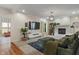 Cozy living room with a fireplace, large TV, comfortable seating, and plenty of natural light at 4601 Fairhope Dr, Indianapolis, IN 46237