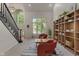 Bright living room with tall ceilings, a staircase, large windows, and a cozy seating area at 4601 Fairhope Dr, Indianapolis, IN 46237