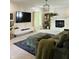 Cozy living room with fireplace, large screen television, plush seating, and a comfortable ottoman on top of soft carpet at 4601 Fairhope Dr, Indianapolis, IN 46237