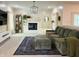 Bright living room with fireplace, large screen television, plush seating and rug over soft carpet for comfort and style at 4601 Fairhope Dr, Indianapolis, IN 46237
