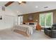 Comfortable main bedroom featuring neutral tones, plush carpet, and a cozy reading nook at 4601 Fairhope Dr, Indianapolis, IN 46237