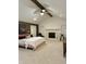 Bright main bedroom with vaulted ceiling, fireplace, king bed, and wooden beams, creating a serene retreat at 4601 Fairhope Dr, Indianapolis, IN 46237