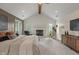 Bright main bedroom with vaulted ceilings, a fireplace, and a neutral color palette at 4601 Fairhope Dr, Indianapolis, IN 46237