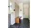 Mud room featuring sleek built-in bench with coat hooks, tile flooring, and natural light from window at 4601 Fairhope Dr, Indianapolis, IN 46237