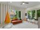 Charming playroom with a hanging chair, comfortable seating, and abundant natural light at 4601 Fairhope Dr, Indianapolis, IN 46237