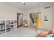 Bright playroom with a fun hanging chair, toy storage, and easy access to other areas of the home at 4601 Fairhope Dr, Indianapolis, IN 46237
