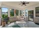 Relaxing sunroom with brick accents, cozy hammock, and plenty of natural light at 4601 Fairhope Dr, Indianapolis, IN 46237
