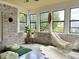 Bright sunroom featuring whitewashed brick, comfortable hammock, and tranquil views at 4601 Fairhope Dr, Indianapolis, IN 46237