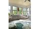 Bright sunroom featuring whitewashed brick, comfortable hammock, and tranquil views at 4601 Fairhope Dr, Indianapolis, IN 46237