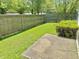 Backyard featuring a well-maintained lawn, wooden fence, and a small concrete patio at 4947 Peony Pl, Indianapolis, IN 46254