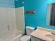 A blue bathroom with a shower, toilet, and vanity at 4947 Peony Pl, Indianapolis, IN 46254