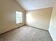Bright bedroom featuring neutral carpeting, a high ceiling, and a window providing natural light at 4947 Peony Pl, Indianapolis, IN 46254