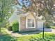 Side view of the home with brick and vinyl siding with manicured lawn at 4947 Peony Pl, Indianapolis, IN 46254