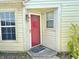 Home's front entrance, showcasing a red door, decorative lighting, and well-maintained landscaping at 4947 Peony Pl, Indianapolis, IN 46254