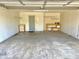 Spacious garage with concrete floors, utility shelving, and access door at 4947 Peony Pl, Indianapolis, IN 46254