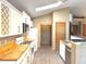 A modern kitchen with white cabinetry, wooden countertops, and stainless steel appliances, including a gas range and microwave at 4947 Peony Pl, Indianapolis, IN 46254