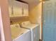 A laundry room with a washer, dryer, and overhead cabinets at 4947 Peony Pl, Indianapolis, IN 46254