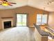 Bright and airy living room featuring a fireplace, with sliding glass doors, and an open bar area at 4947 Peony Pl, Indianapolis, IN 46254