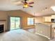 The open living area features high ceilings, a fireplace, and a sliding door leading to the yard at 4947 Peony Pl, Indianapolis, IN 46254