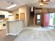 Open-concept living area with modern kitchen, a staircase, and a view of the front door at 4947 Peony Pl, Indianapolis, IN 46254
