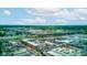 A high-angle view of a racetrack, buildings, and greenery under a partly cloudy sky at 4956 W 11Th St, Speedway, IN 46224