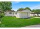 View of detached garage and side yard in a backyard with healthy, green grass at 4956 W 11Th St, Speedway, IN 46224