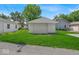 Backyard with a green lawn, a detached garage, and a private driveway at 4956 W 11Th St, Speedway, IN 46224
