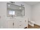 Bright bathroom with a dual sink vanity, modern fixtures, and wood-look flooring at 4956 W 11Th St, Speedway, IN 46224