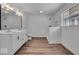 Renovated bathroom with double sink vanity and tile shower walls at 4956 W 11Th St, Speedway, IN 46224