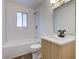 A beautifully updated bathroom with new fixtures and tile in the shower/tub area at 4956 W 11Th St, Speedway, IN 46224