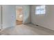 A bright bedroom featuring neutral carpeting, ensuite bathroom, and natural light from a window at 4956 W 11Th St, Speedway, IN 46224