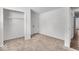 Bedroom featuring neutral carpeting, closet and access to hardwood floor hallway at 4956 W 11Th St, Speedway, IN 46224