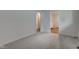 A well-lit room boasts plush neutral carpets and an ensuite bathroom, illuminated by natural light at 4956 W 11Th St, Speedway, IN 46224