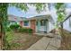 Charming single-story home featuring a brick facade and a well-maintained front yard at 4956 W 11Th St, Speedway, IN 46224