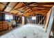 Unfinished garage interior featuring concrete floor, exposed beams, and natural lighting at 4956 W 11Th St, Speedway, IN 46224