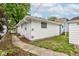 Detached one car garage with white siding and a small side yard at 4956 W 11Th St, Speedway, IN 46224