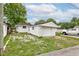 Side view of a white, detached single-car garage with a small yard at 4956 W 11Th St, Speedway, IN 46224