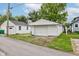 Detached one car garage with white siding and a driveway at 4956 W 11Th St, Speedway, IN 46224