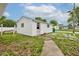 Exterior view of detached white garage with small window and side door at 4956 W 11Th St, Speedway, IN 46224