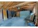 Unfinished garage with concrete floor, exposed wood beams, and an automatic door at 4956 W 11Th St, Speedway, IN 46224