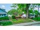 View of front yard with grass and trees surrounding a brick home at 4956 W 11Th St, Speedway, IN 46224