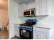 Modern kitchen featuring stainless appliances, white cabinets, and contemporary finishes at 4956 W 11Th St, Speedway, IN 46224