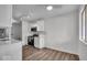 Well-lit kitchen featuring stainless steel appliances, white cabinets, and modern flooring at 4956 W 11Th St, Speedway, IN 46224