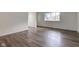 Spacious living room featuring new laminate flooring and ample natural light at 4956 W 11Th St, Speedway, IN 46224